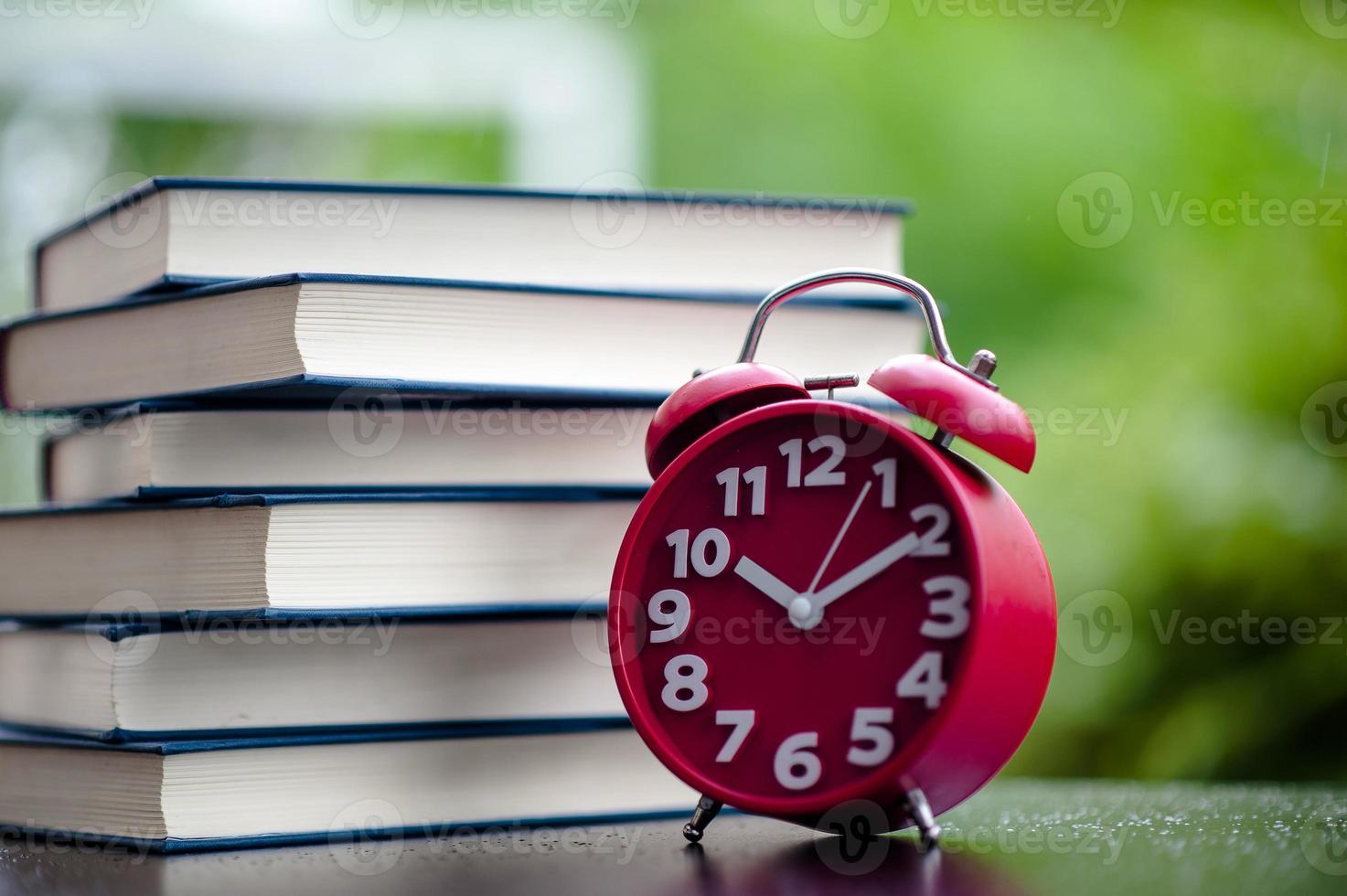 Books and red clocks. Put on the floor. White leather Book and study The concept of empathy and development photo