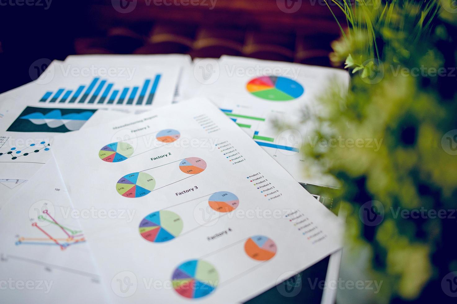 A desk with a business notebook, chart and table top. Top view with copy space photo