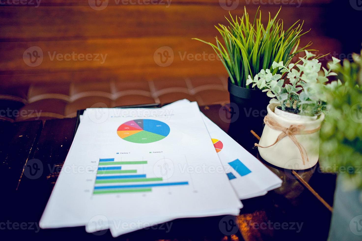 A desk with a business notebook, chart and table top. Top view with copy space photo