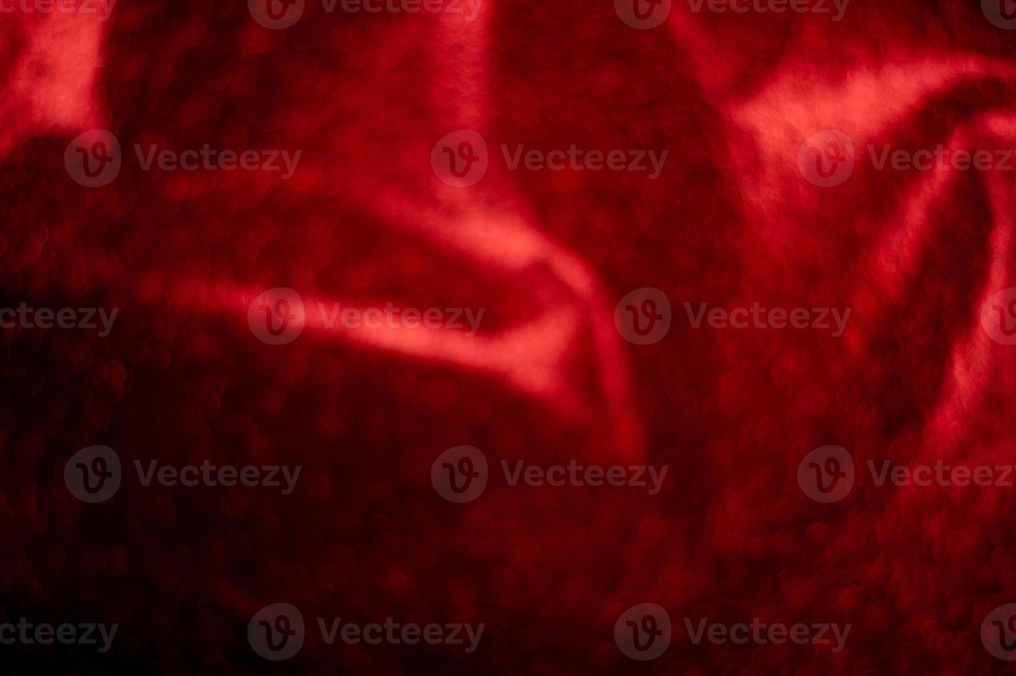 The background is red, the image is blurred and the bokeh has a sparkling light. And there is a copy space. photo