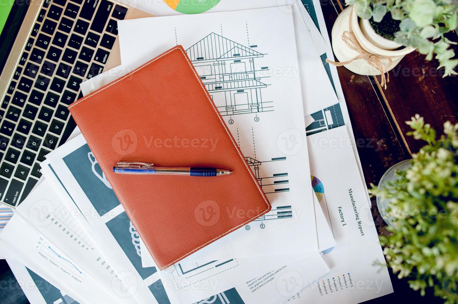 Business desk with business notebook, desk, pen, paper, table graph, top view with copy space photo