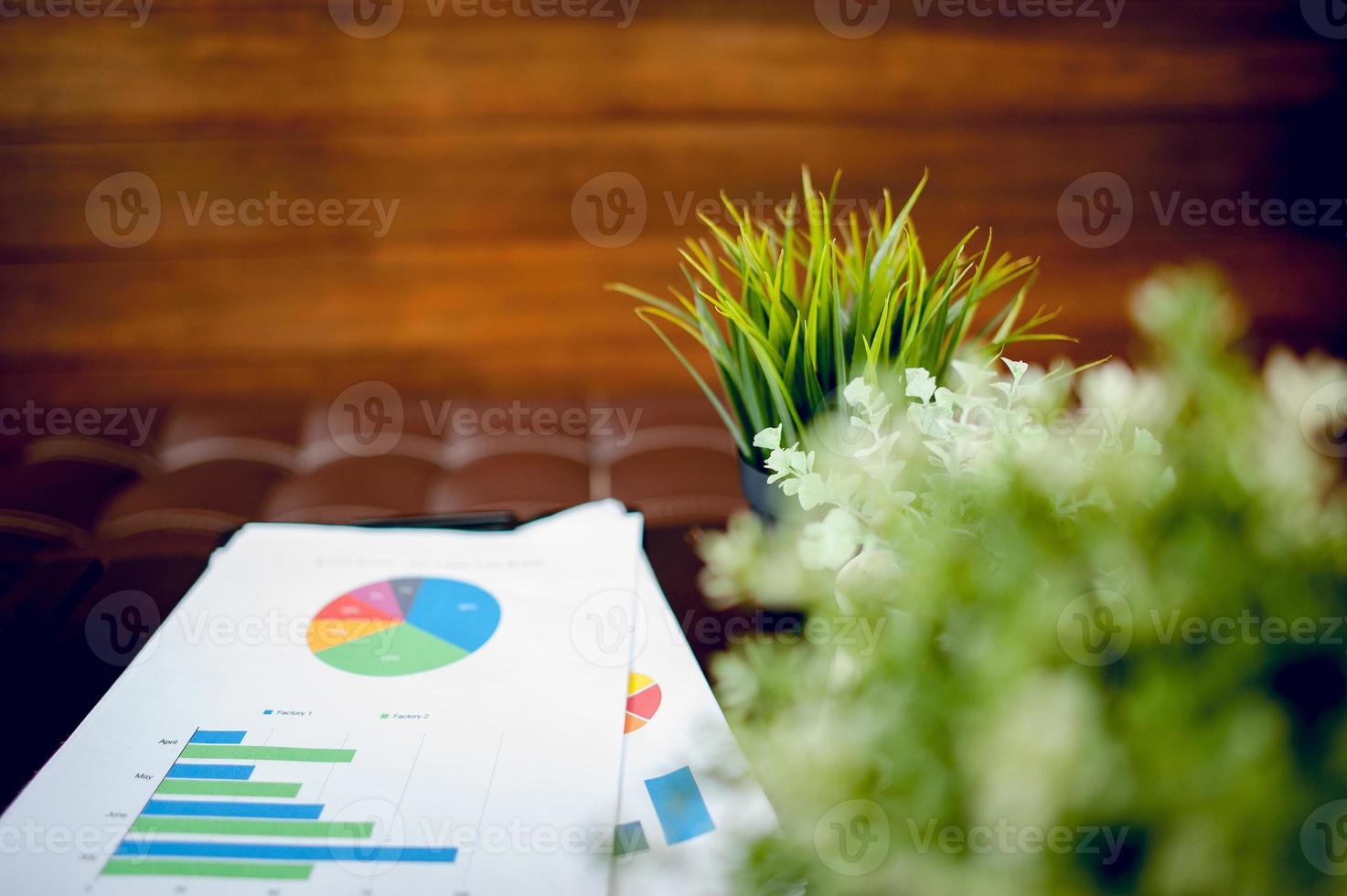 Business desk with business notebook, graph paper, pen on desk, top view with copy space. photo