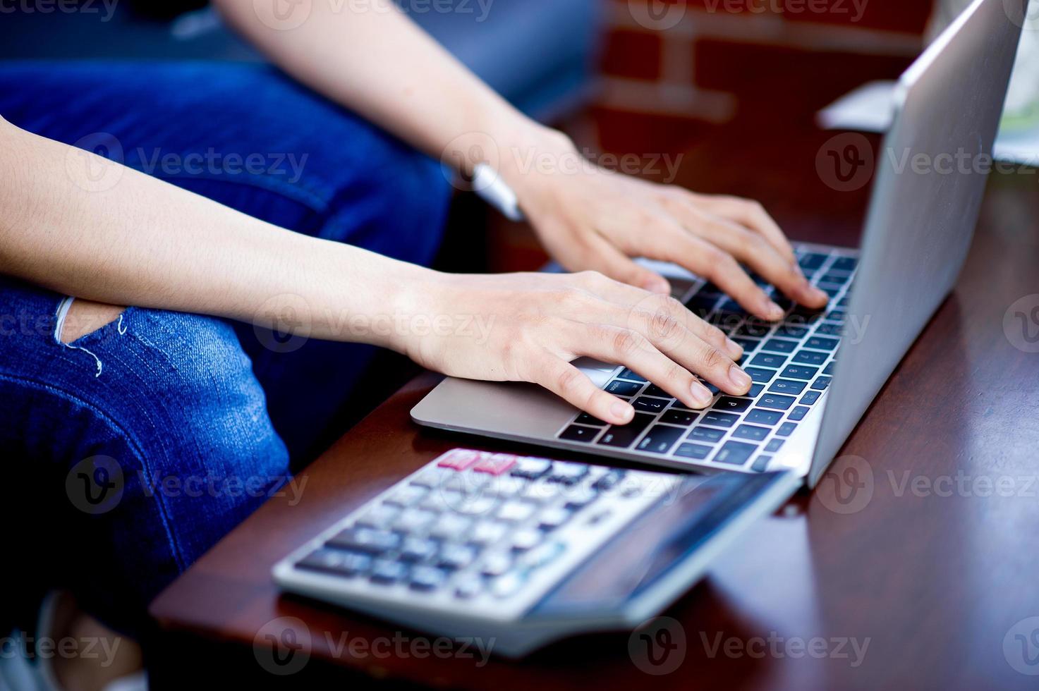 Hand and computer of the girl doing business online. Business concept with copy space photo