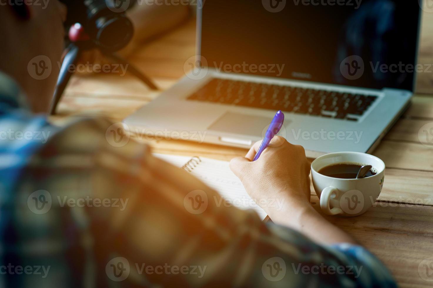 Writing on paper at work on the table in the morning, business ideas. There is space for copying. photo