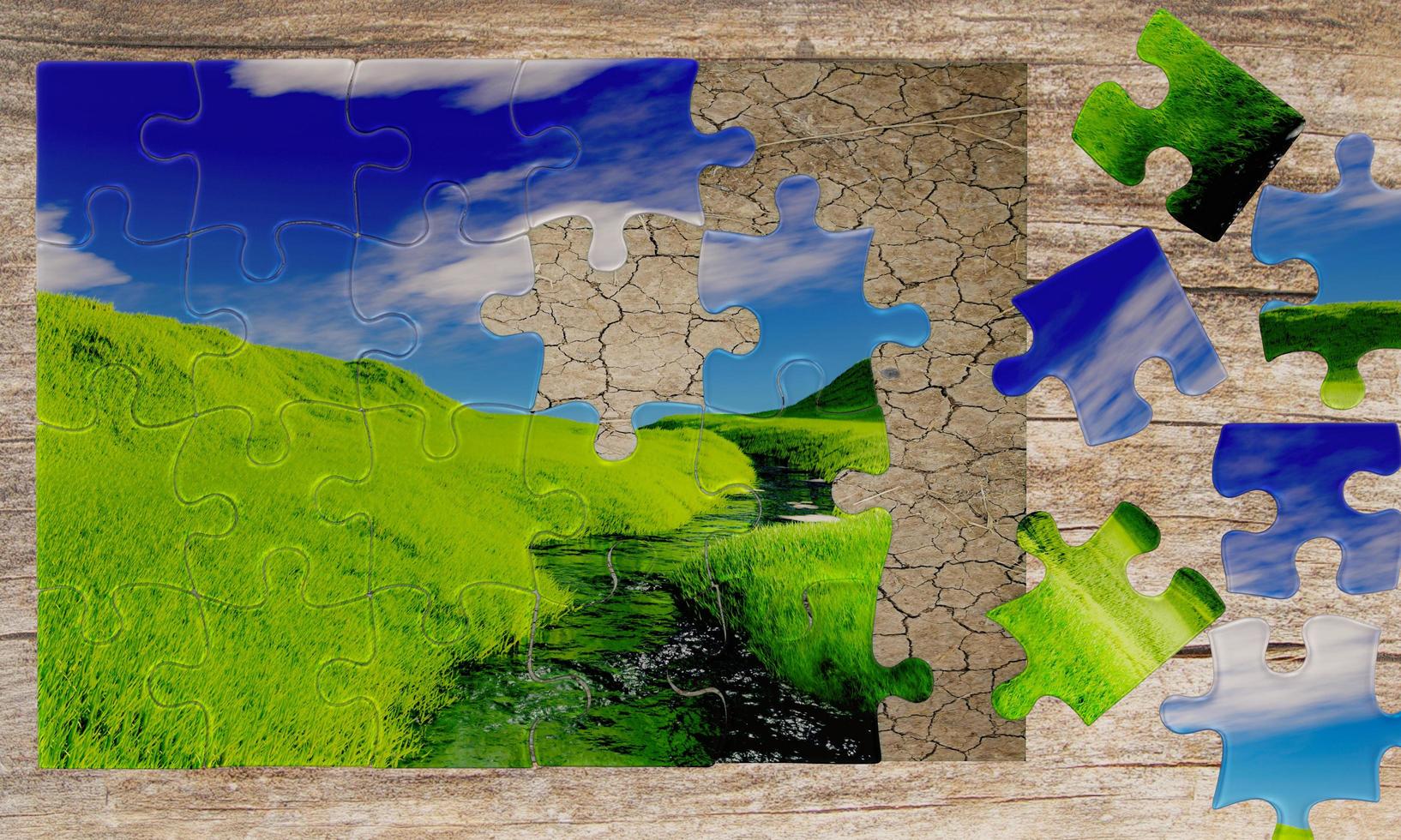 Jigsaw or Puzzle overlapping images between The picture of the ground is arid and parched with green fields. With streams running through the Bright sky and white clouds. 3D Rendering photo