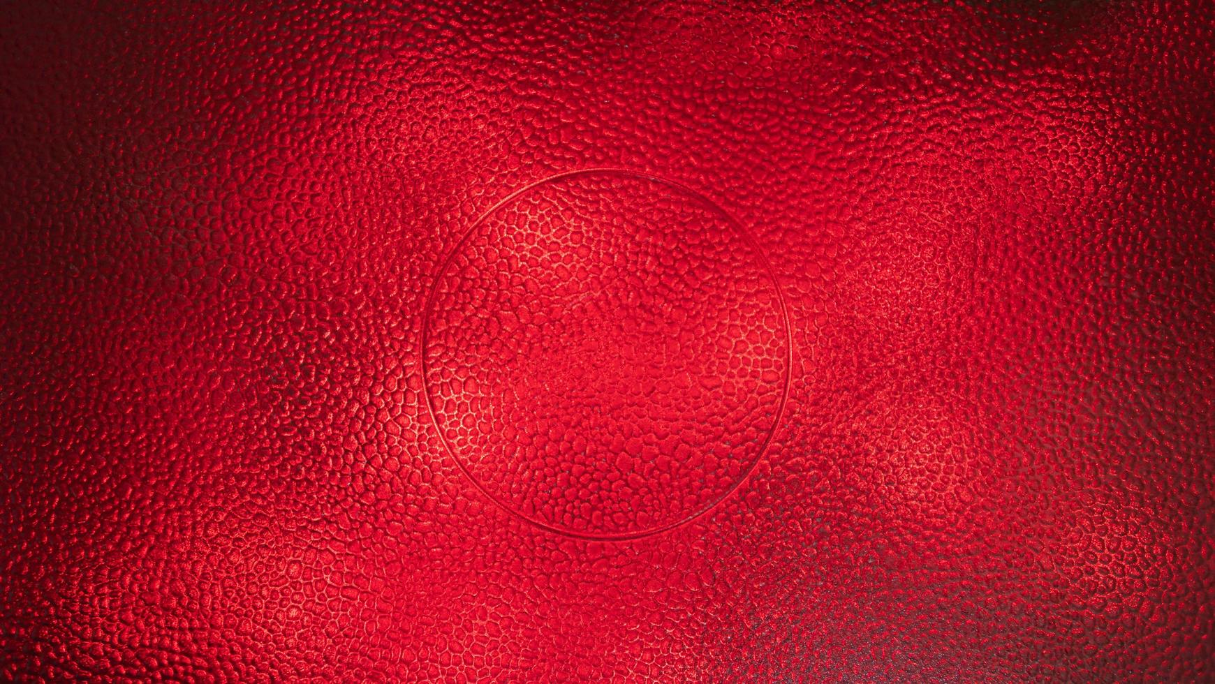 The rough surface of the microwavable glass plate and has a circular groove in the center. Shines with red lights from below to be Background color. photo