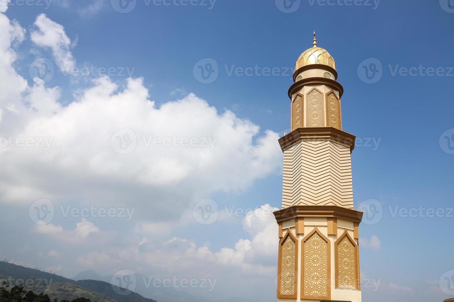 Tower of the mosque with blue sky background photo