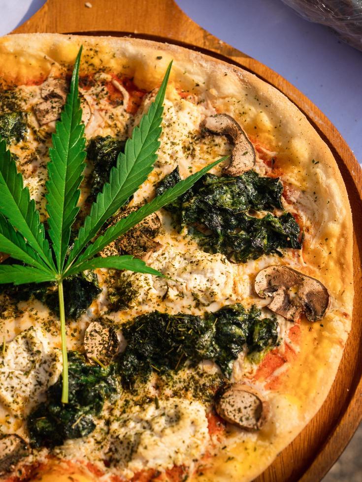 Pizza mix with marijuana or cannabis leaves. photo