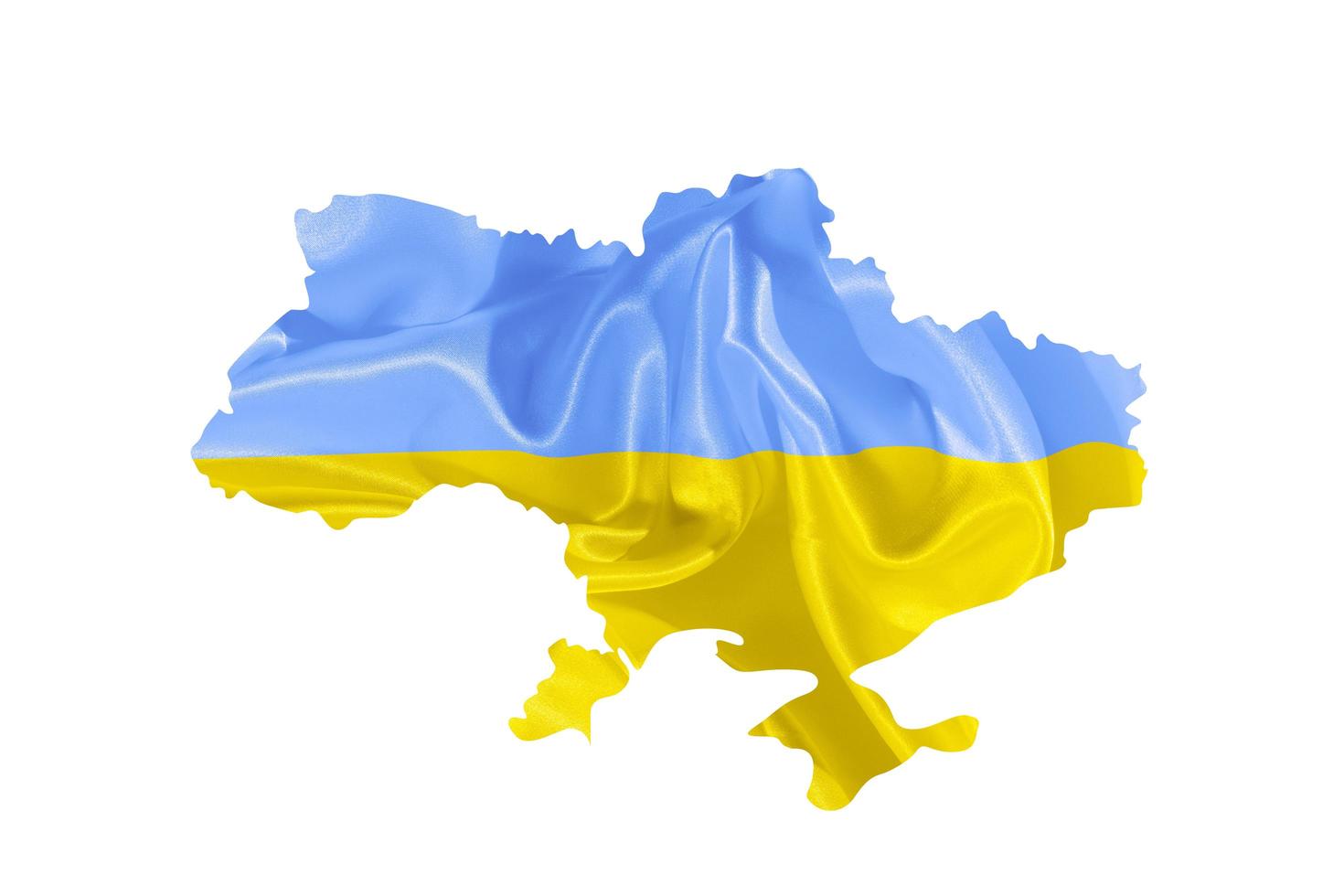 Ukrainian yellow and blue fabric flag in country map silhouette with copy space photo