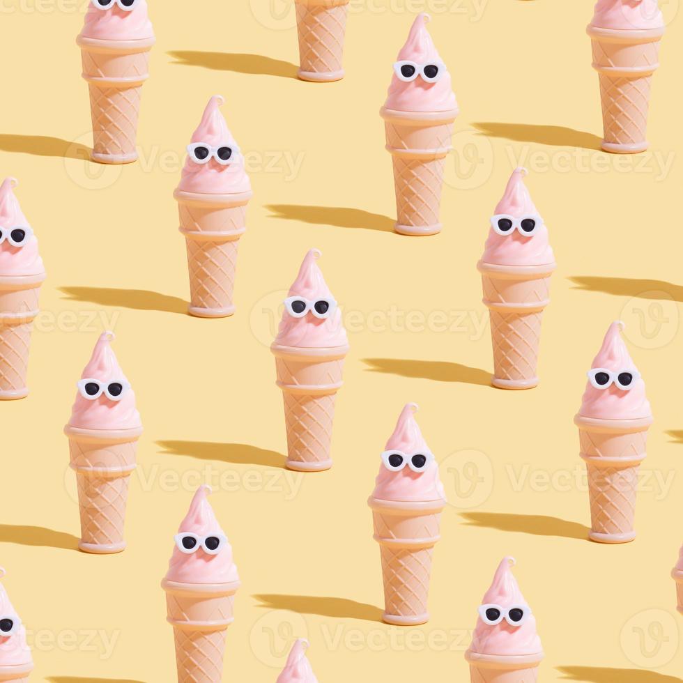 Creative pattern with toy Ice cream cone with sunglasses. Summer vacation in hot weather minimalistic concept photo