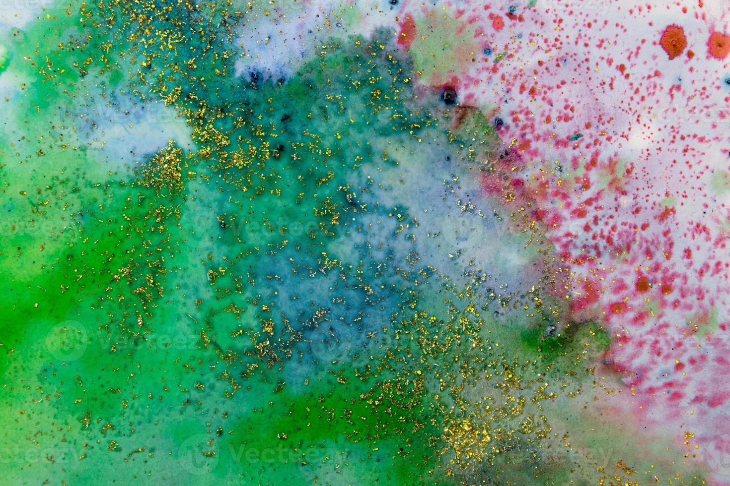 Blue-green watercolor stains with sparkles. Abstract background photo