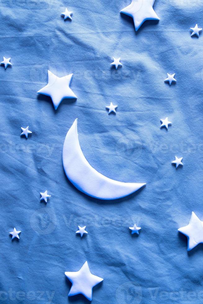 Flat lay composition of the moon and stars on the sheet. Dream creative concept photo