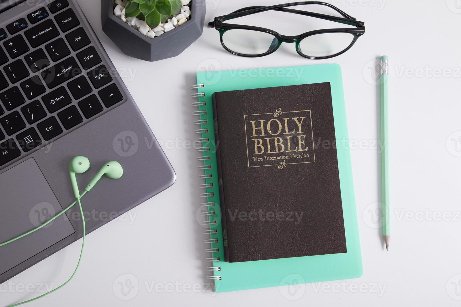 Holy Bible and laptop with headphones. Bible study, worship online concept photo