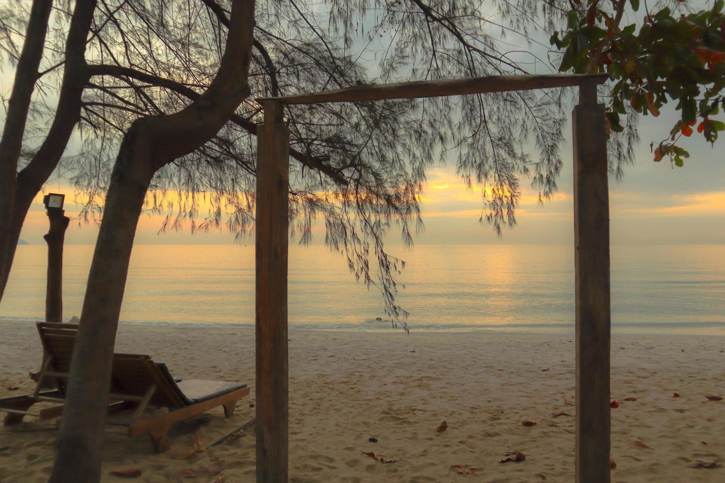 Beautiful sand beach background with soft wave in the morning. photo