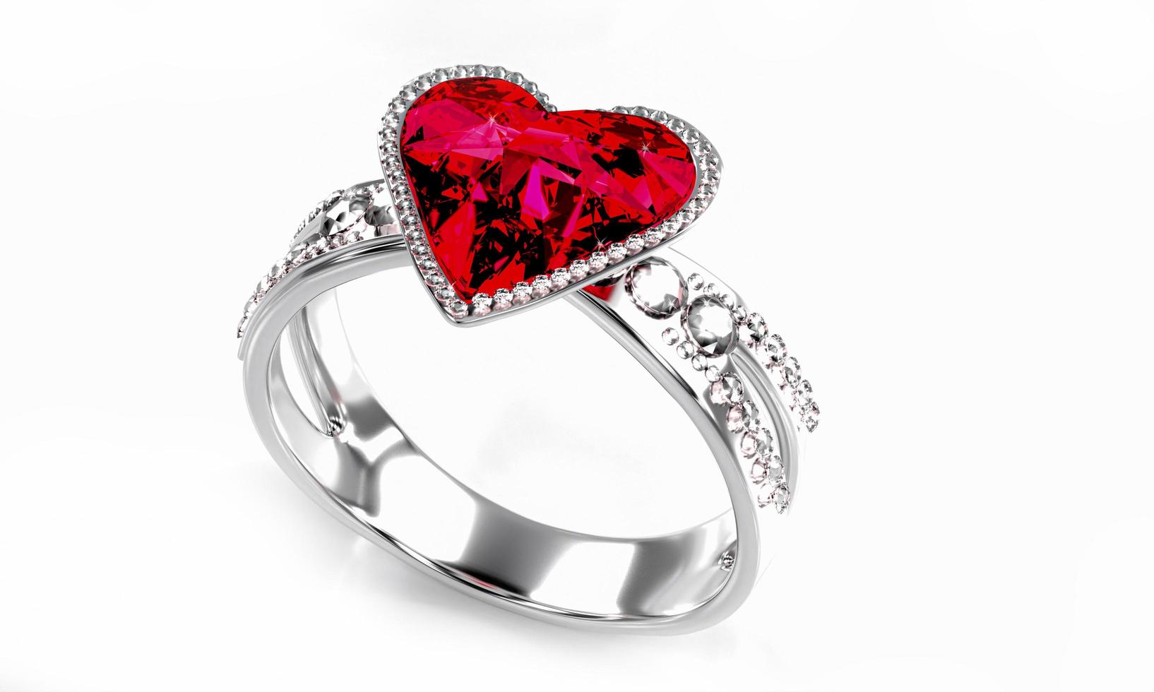 el gran diamante rojo en forma de corazón está rodeado de muchos diamantes en el anillo de oro platino colocado sobre un fondo gris. Elegante anillo de bodas con diamantes para mujer. representación 3d foto