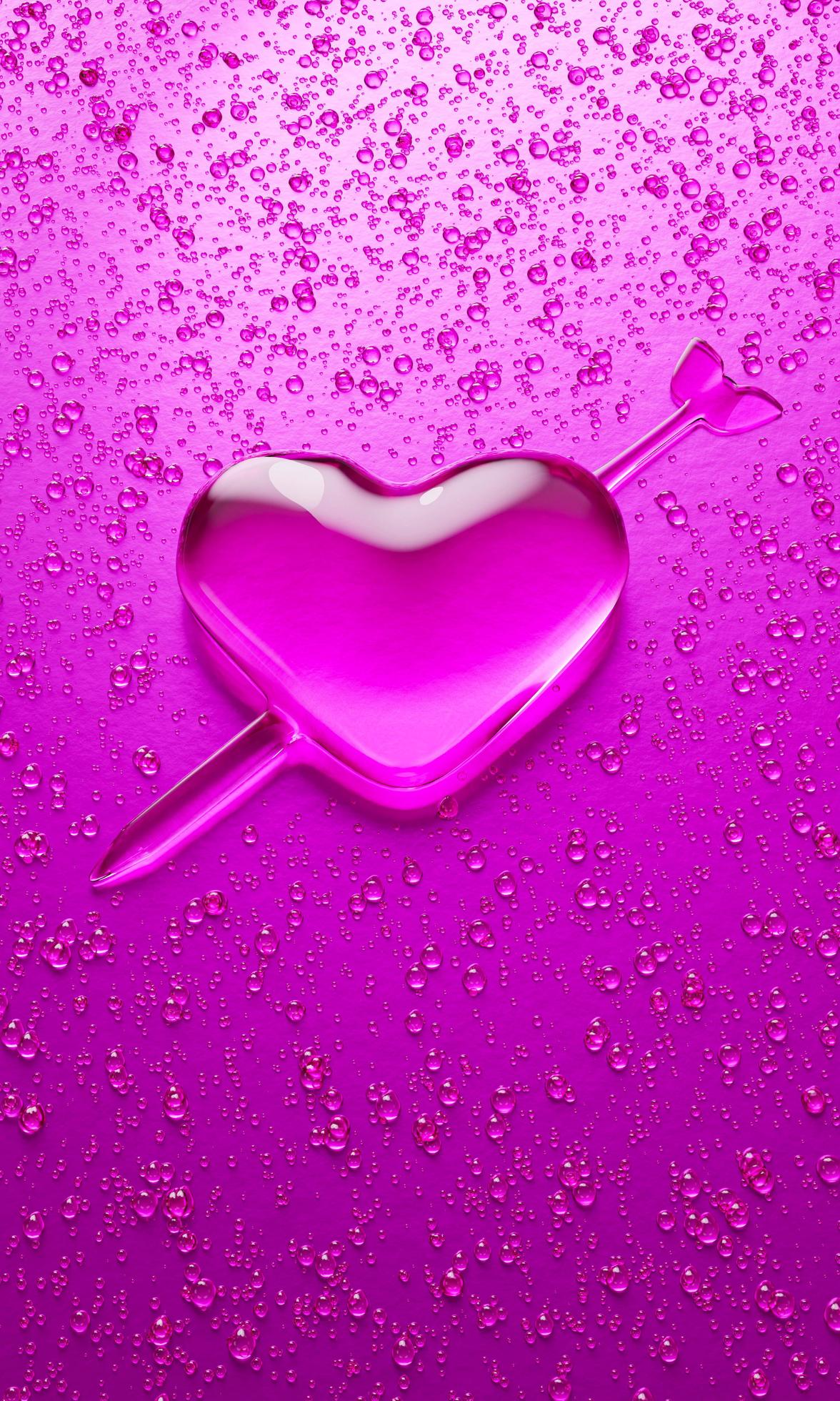 Water droplets in the shape of heart with Arrow embroidered in the meaning  of love. A lot of droplets On metallic surfaces in pink and dark pink  shades for mobile background or