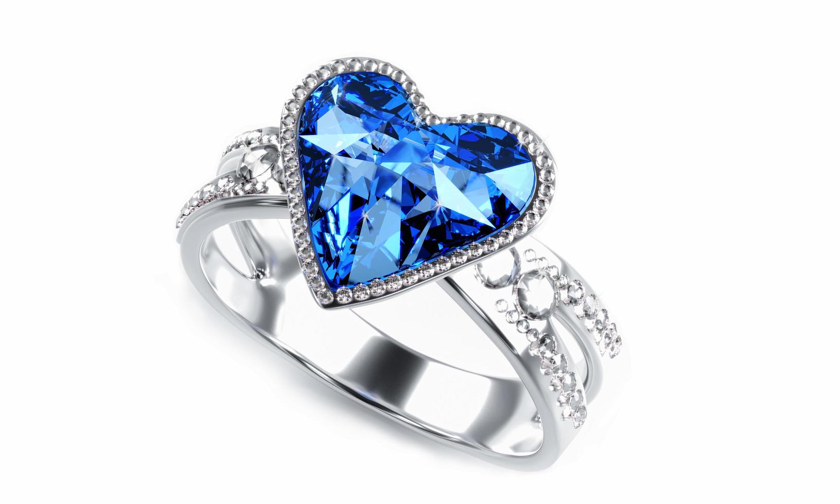 el gran diamante azul en forma de corazón está rodeado de muchos diamantes en el anillo de oro platino colocado sobre un fondo gris. Elegante anillo de bodas con diamantes para mujer. representación 3d foto