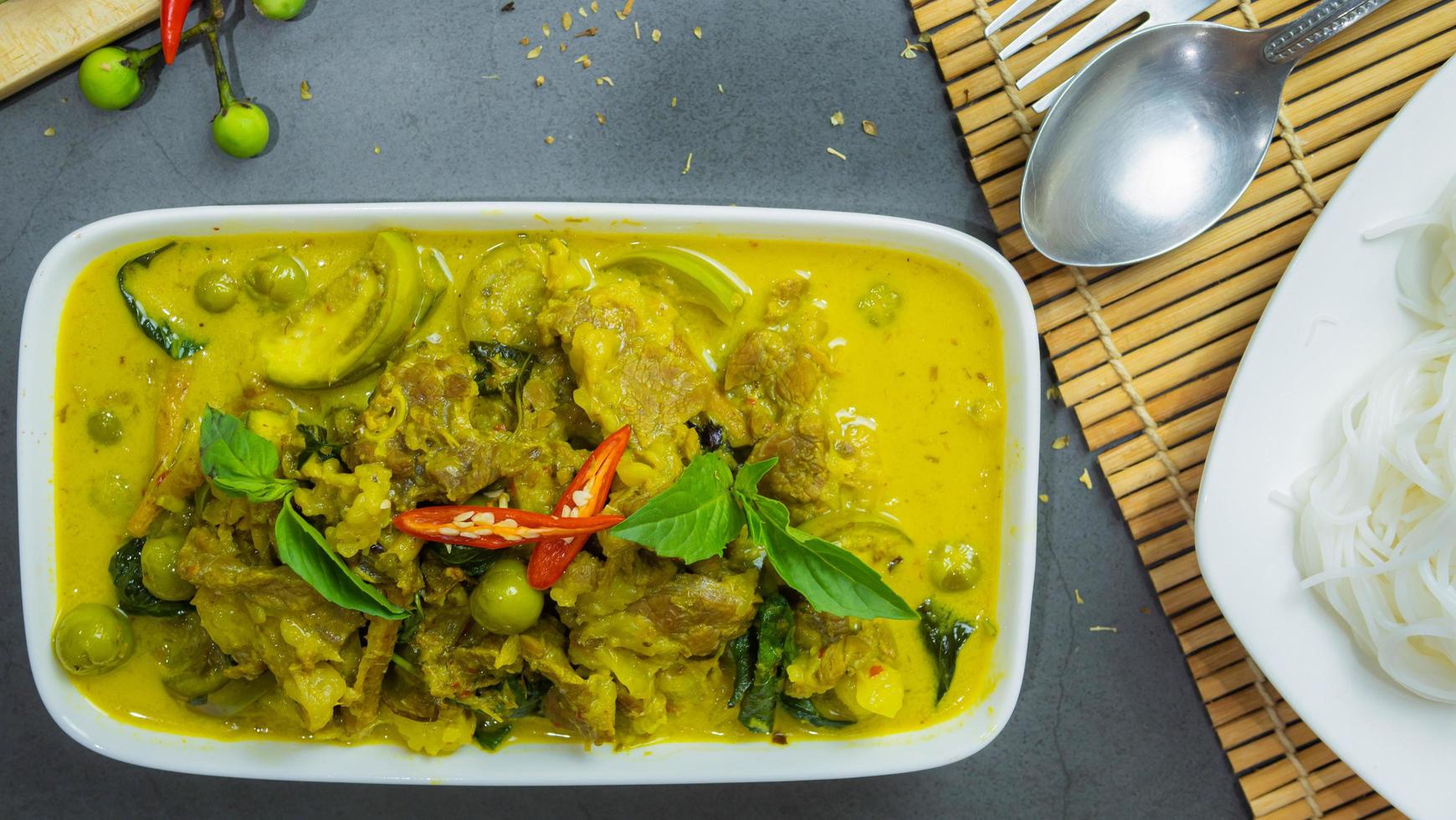 Green curry with beef. Famous food in Thailand. The food consists of curry paste. Blended with herbs Simmered with coconut milk And meat Season with fish sauce and sugar,add brinjal and sweet eggplant photo
