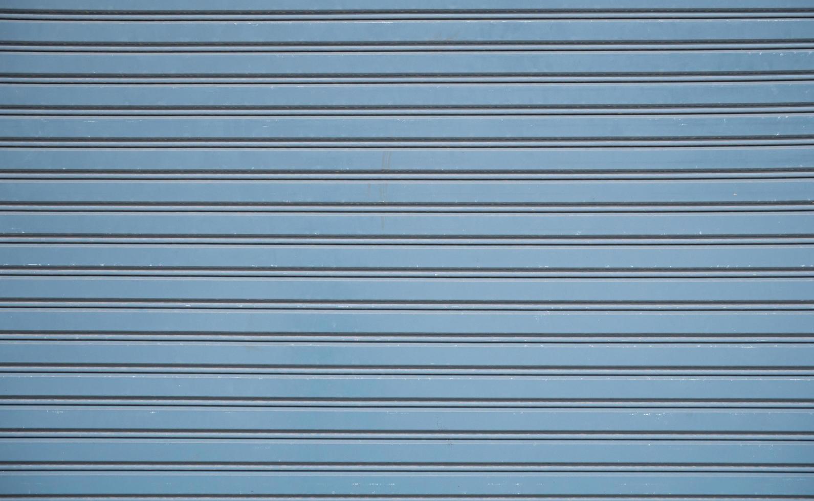 Straight lines or parallel lines of an iron door Rolling doors made of metal. Line pattern, rectangular shape from a rolling door Suitable for making banner, wallpaper or background. photo
