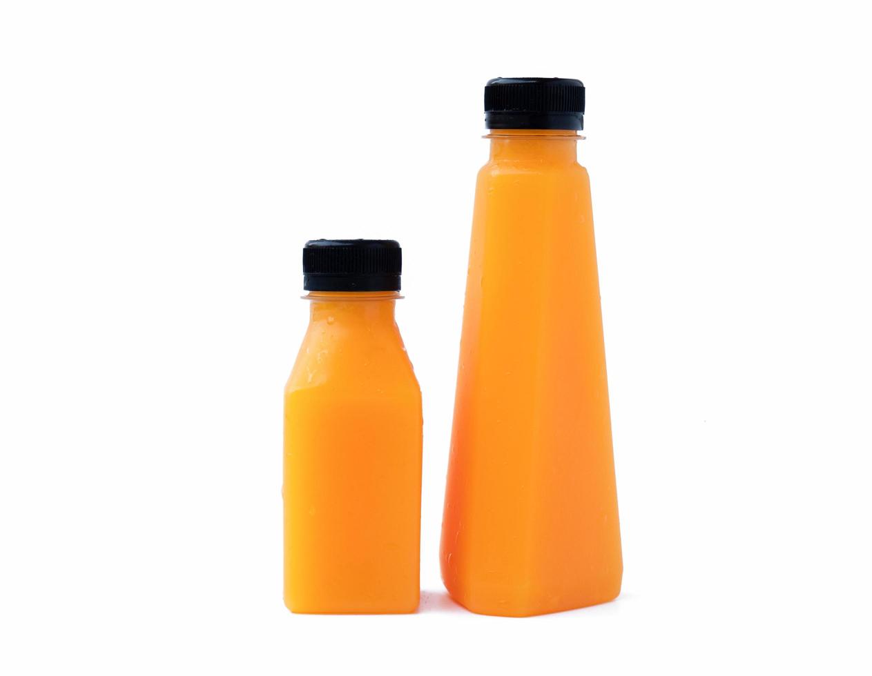 Two bottles of orange juice isolated on a white background. photo