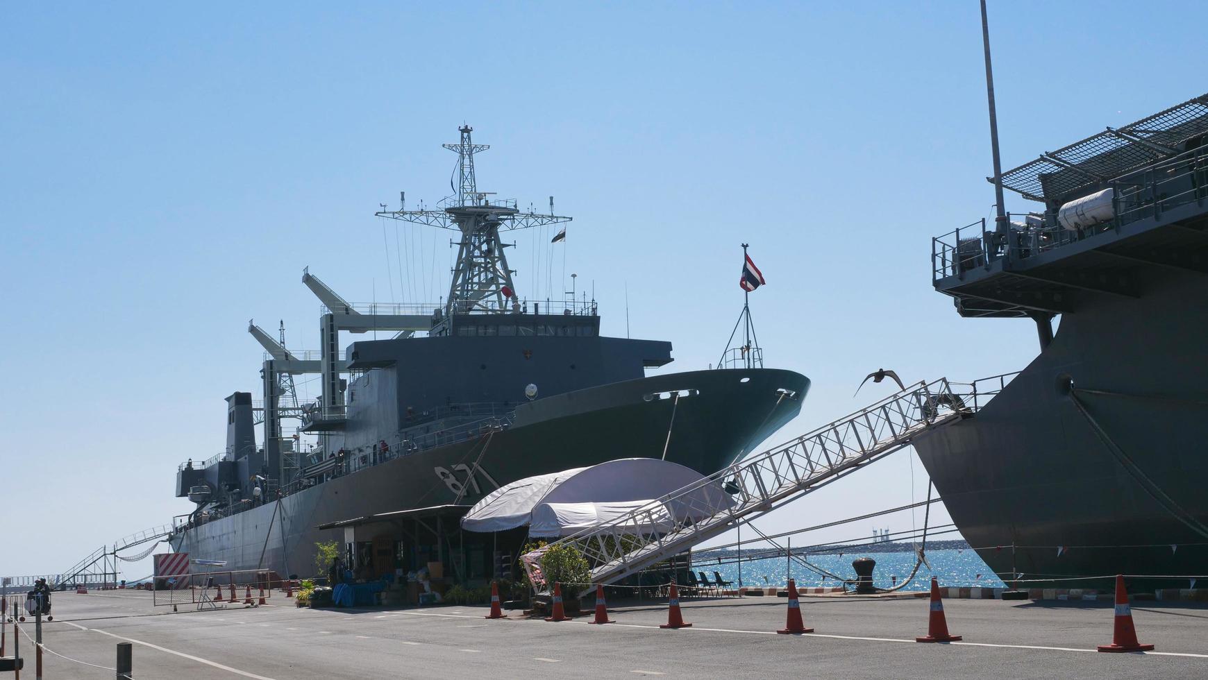 Some pictures of large ships docked, large ships and clear, cloudless skies. Bridge and signal towers. photo