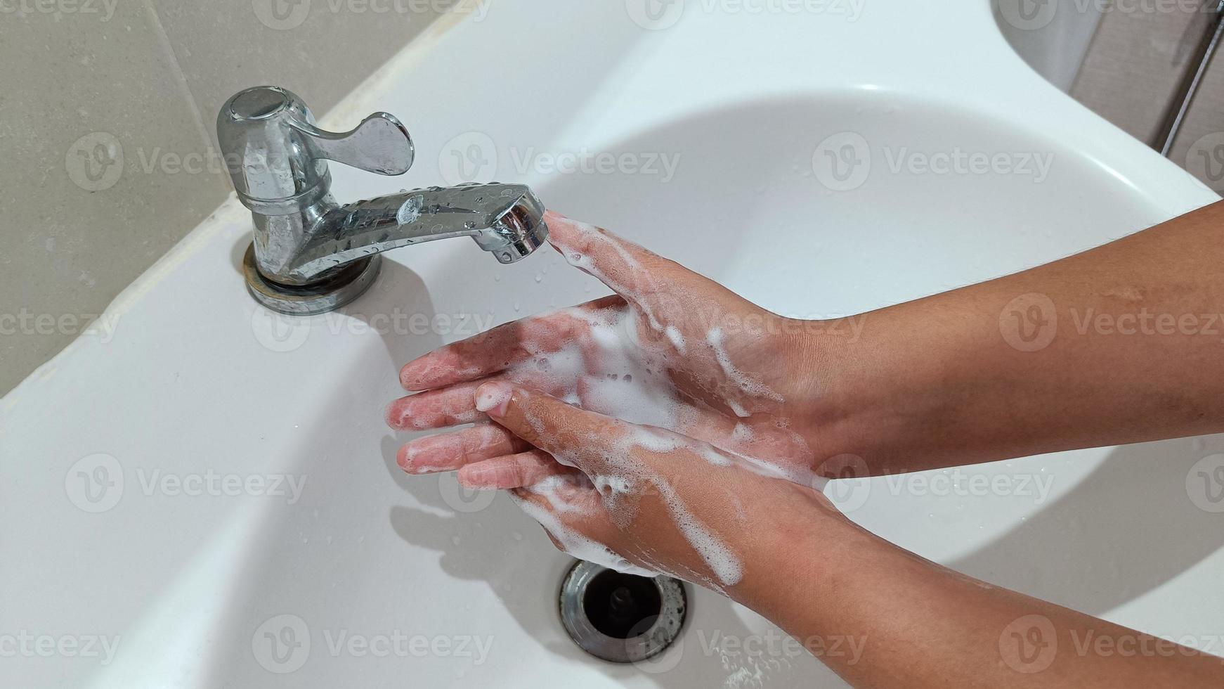 Women are washing their hands photo