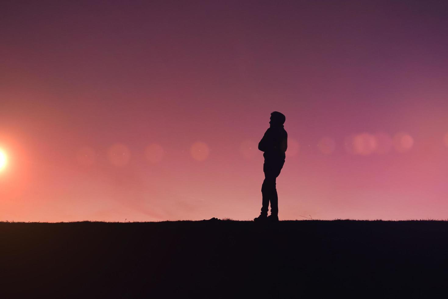 man silhouette trekking in the mountain with a beautiful sunset photo