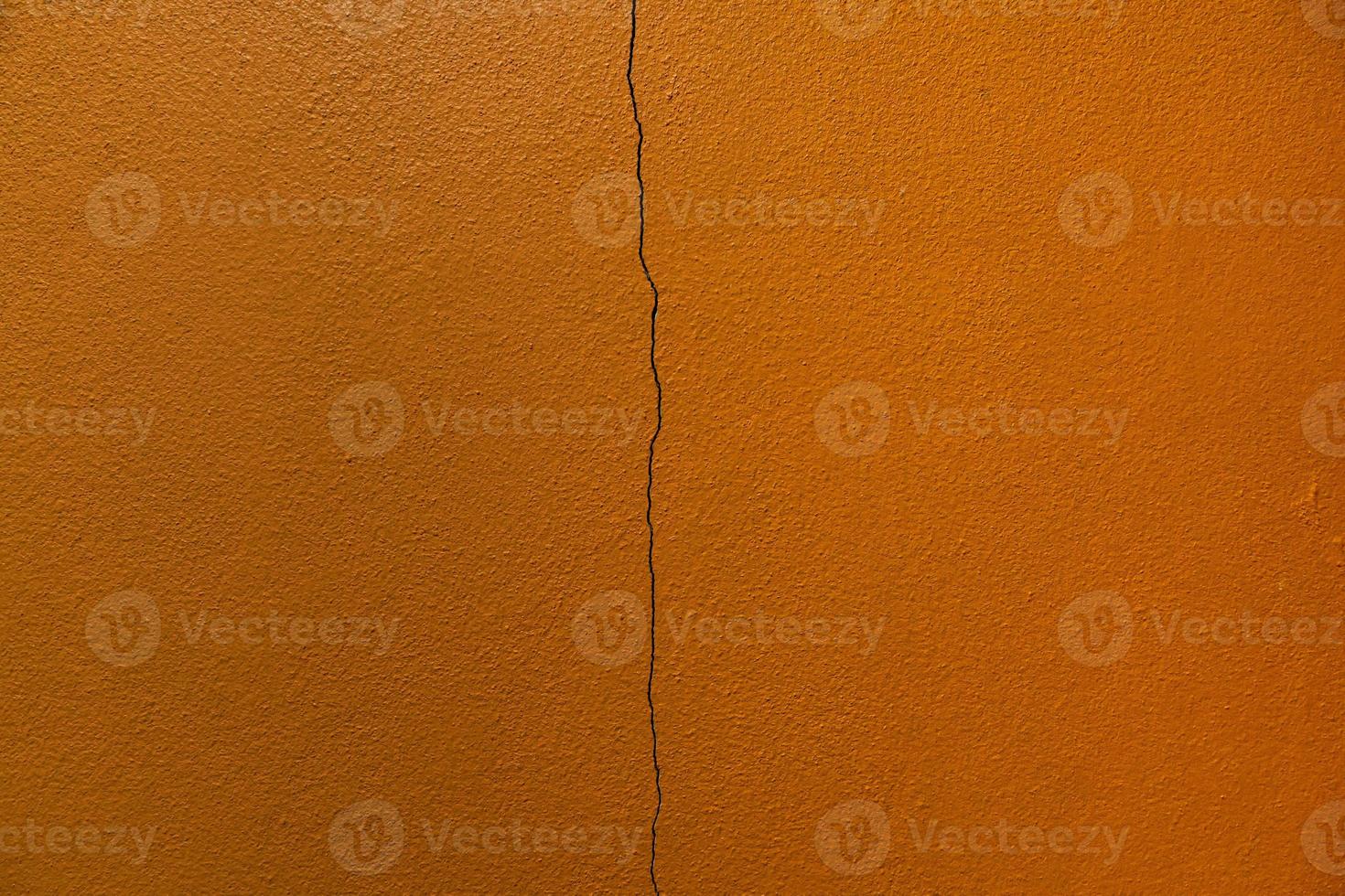 Long cracks of concrete on the wall of the building photo