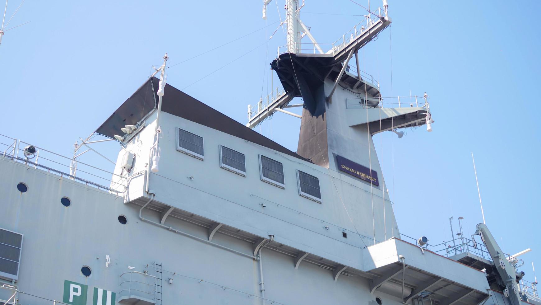 Some pictures of large ships docked, large ships and clear, cloudless skies. Bridge and signal towers. photo