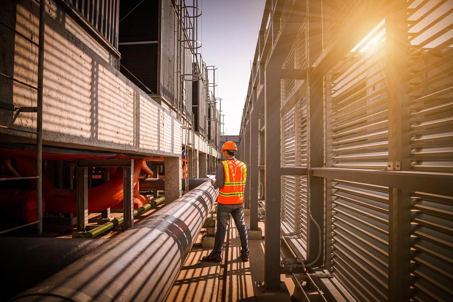 Industry engineer under checking the industry cooling tower air conditioner is water cooling tower air chiller HVAC of large industrial building to control air system. photo