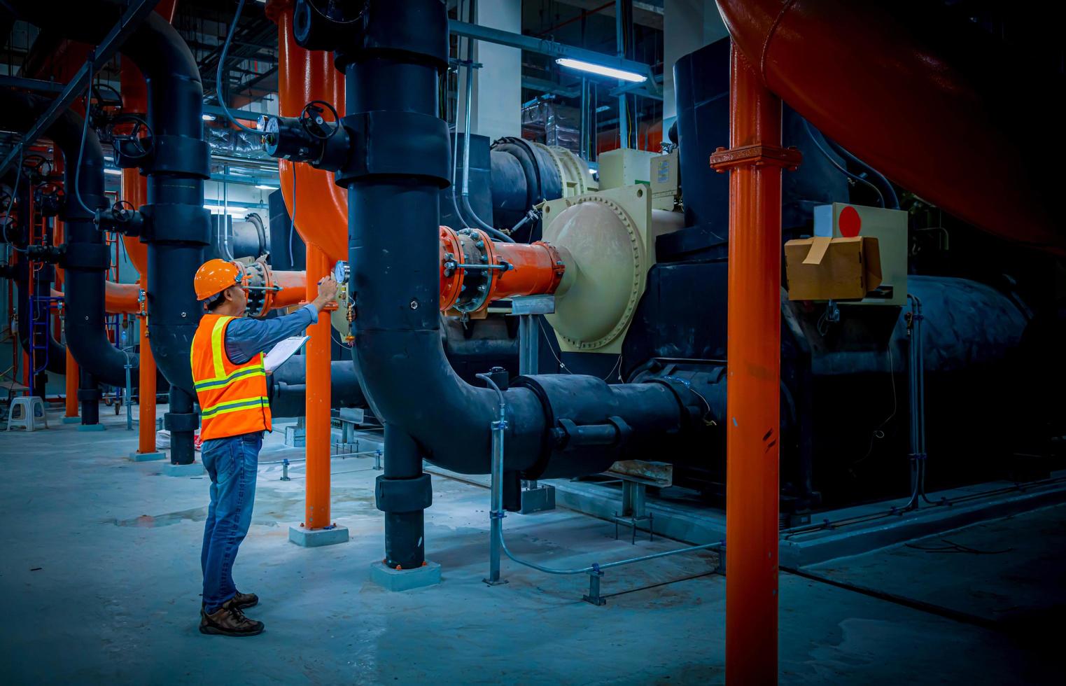 Industry engineer under checking the industry cooling tower air conditioner is water cooling tower air chiller HVAC of large industrial building to control air system. photo