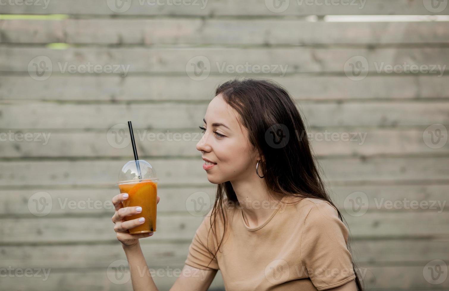 vegetarian woman holds juice photo