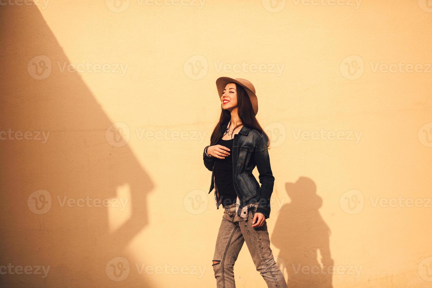Fashionable brunette girl in hat photo