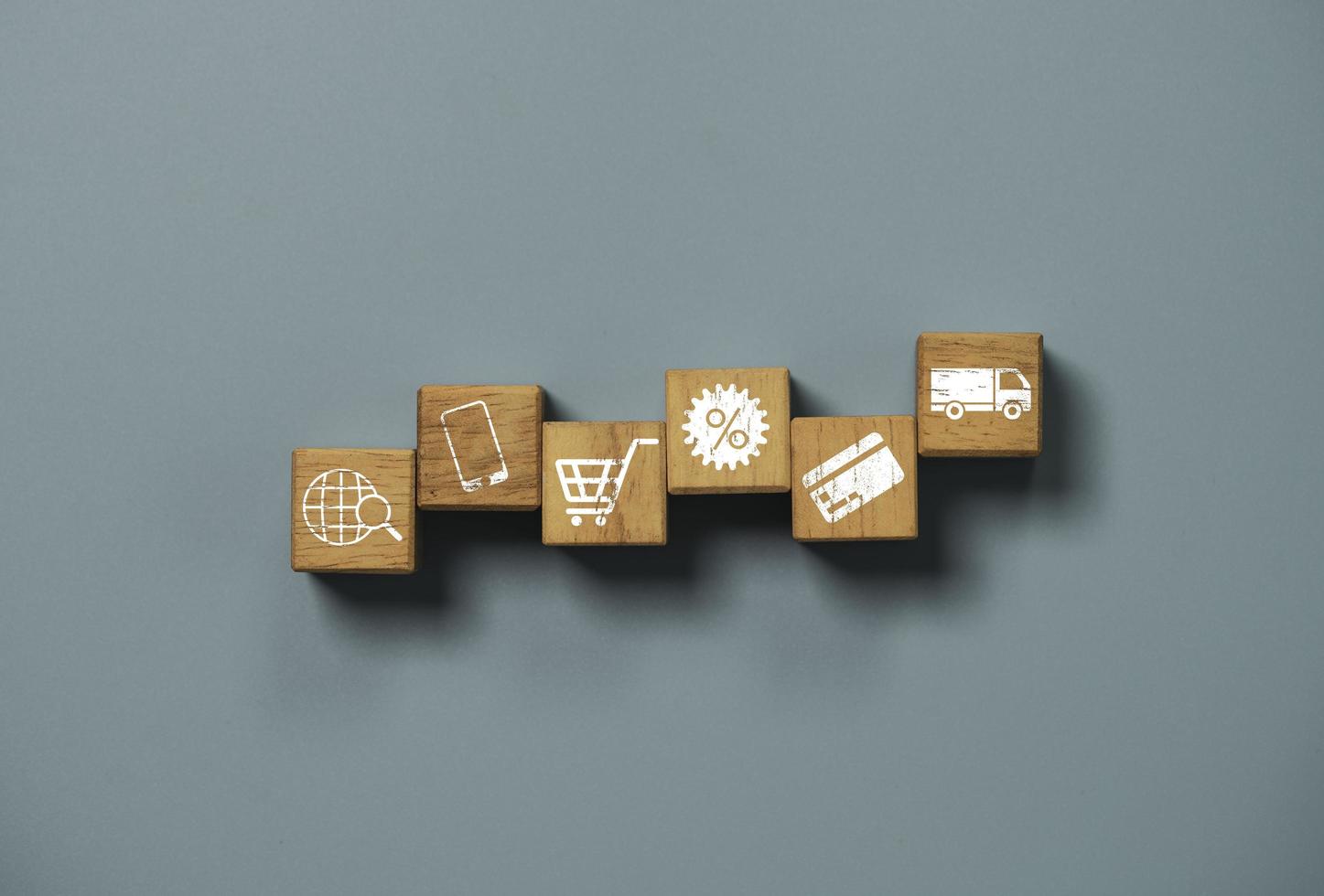 Shopping and e-commerce concept , Online shopping icon include searching mobile phone trolley discount credit card and delivery truck print screen on wooden cube block. photo