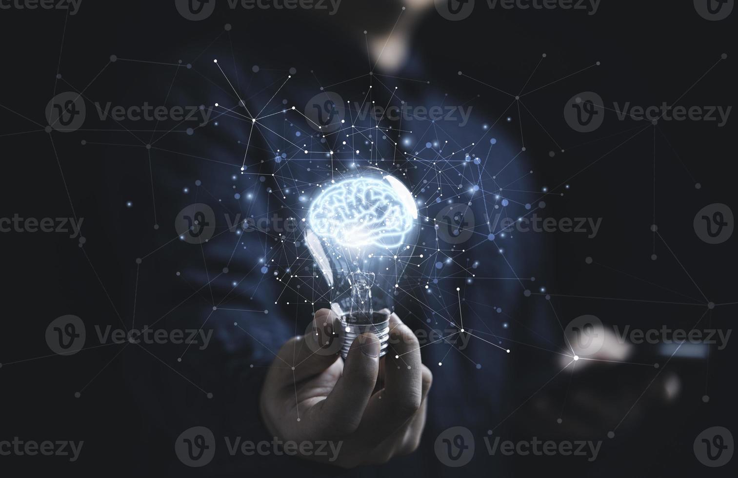 Businessman hand holding lightbulb with glowing virtual brain and  connection line to creative smart thinking for inspiration and innovation with network concept. photo