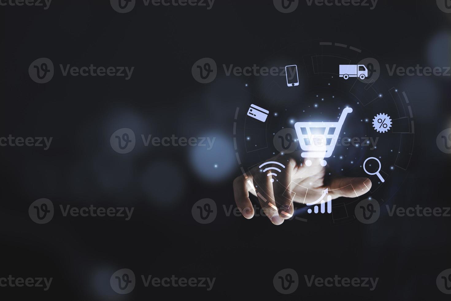 Hand touching to virtual info graphics with trolley cart icons , Technology online shopping business concept. photo