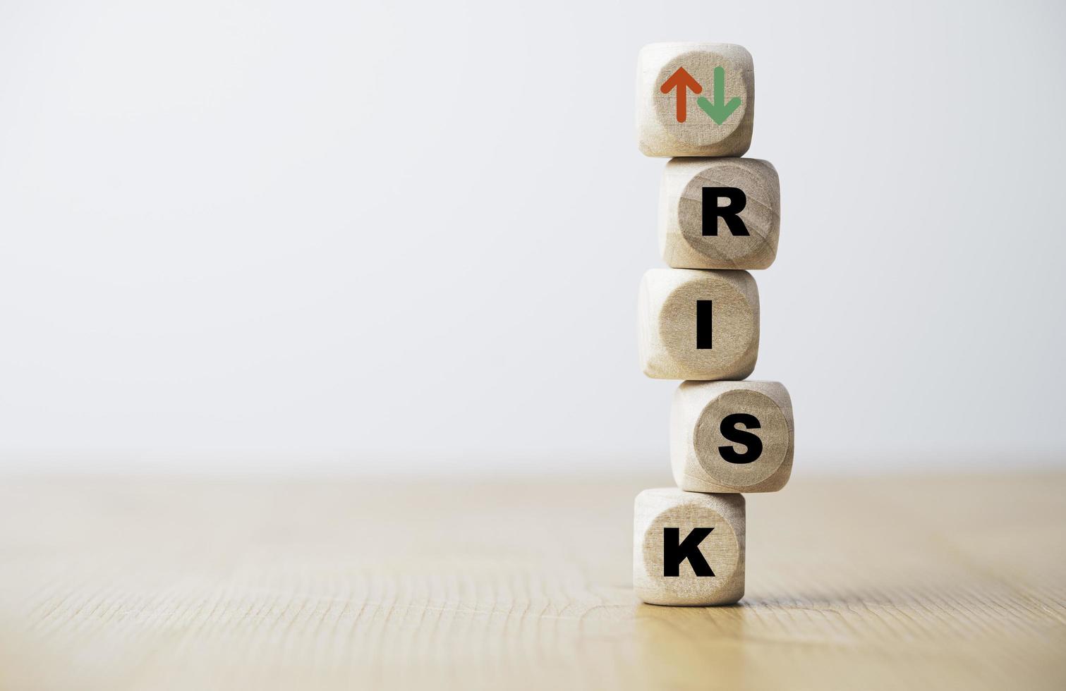 Risk wording and up down arrow print screen wooden cube block for risk management concept. photo
