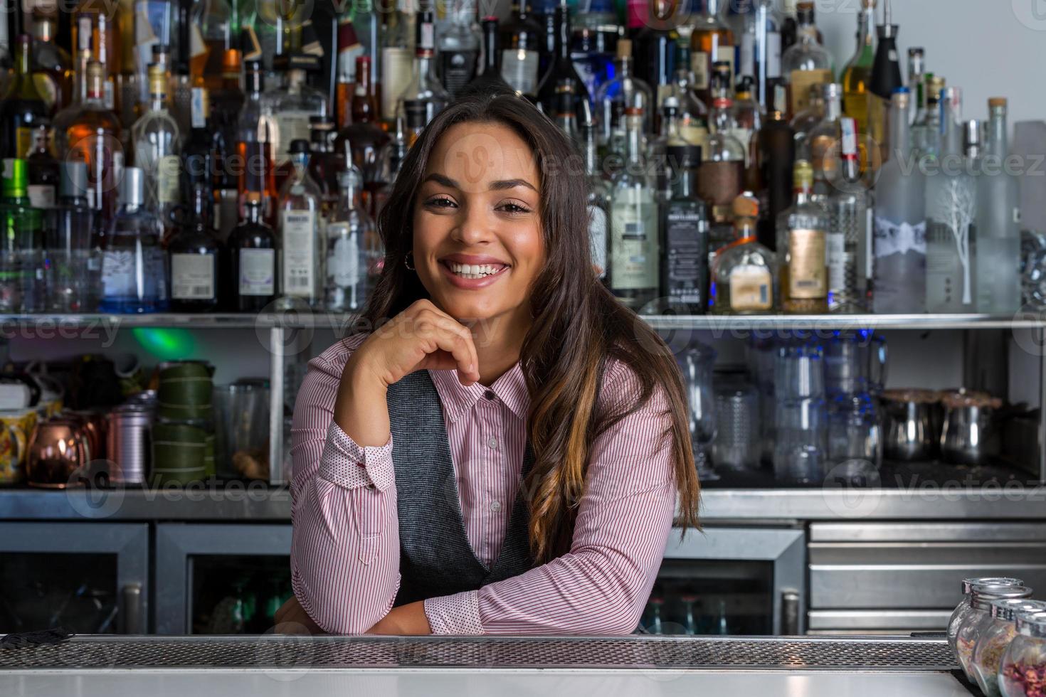 Friendly Hispanic mixologist looking at camera photo