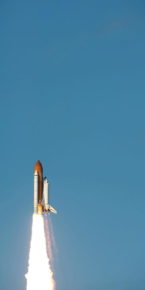 Space Shuttle takes off into space. Elements of this image furnished by NASA. photo