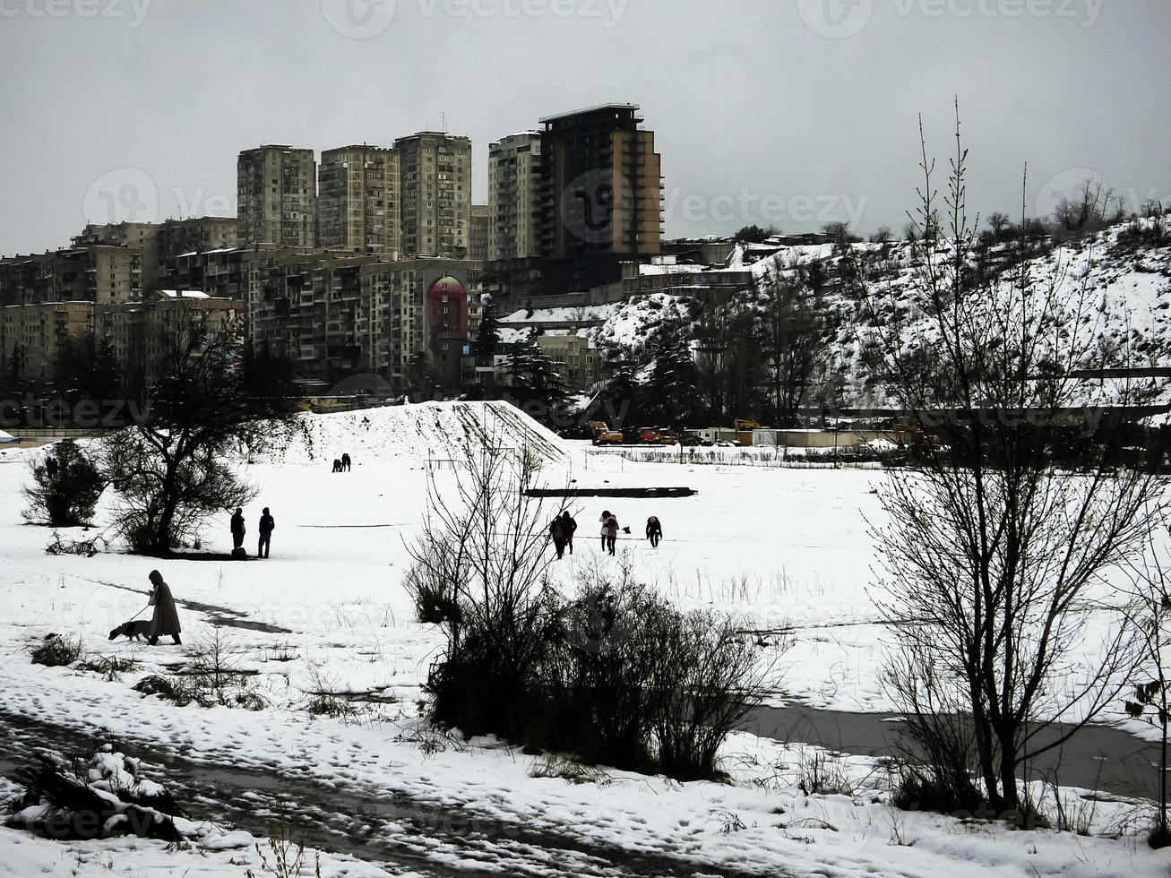 Winter landscape with people walking in snow. photo