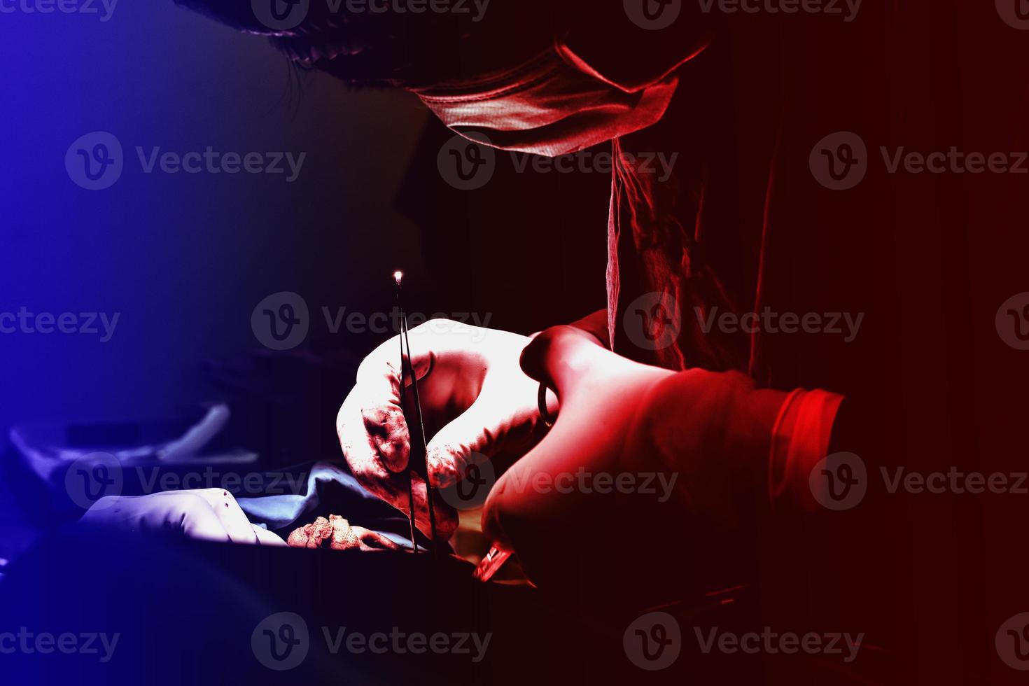 The doctor who is operating in the red and blue atmosphere photo