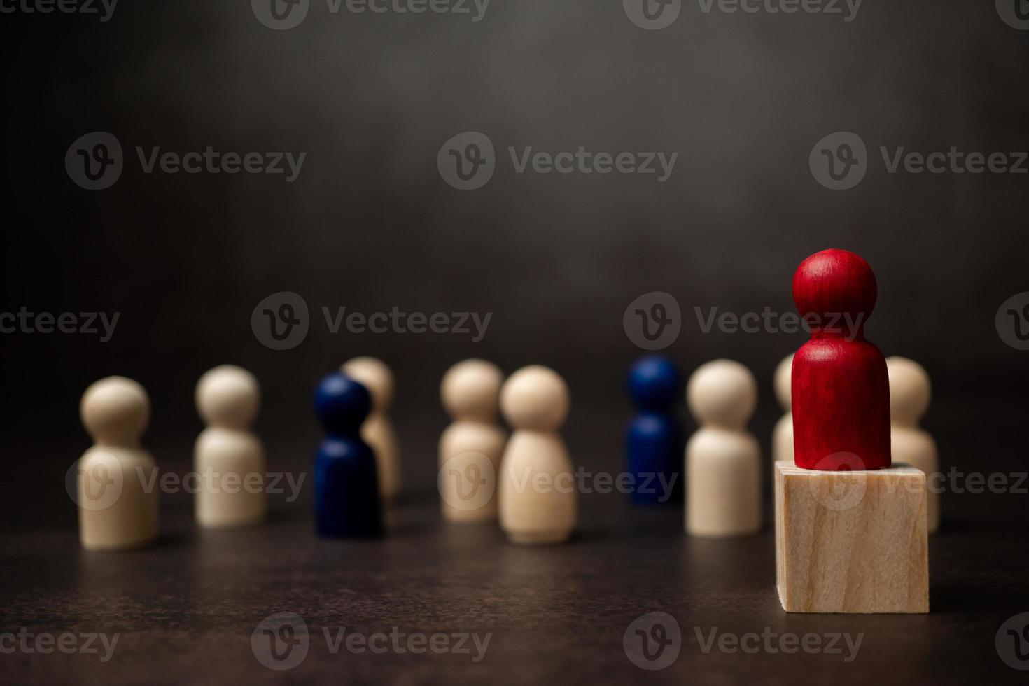 The leadership of the wooden figure standing on the box show influence and empowerment. Concept of business leadership for leader team, successful competition winner and Leader with strategy photo