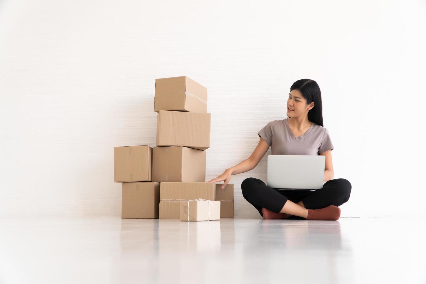 Young asian entrepreneur feeling stress and anxiety resulting from reduced sales after checking orders from customers by laptop. Concept of small business owner. Need a business consultant concept photo