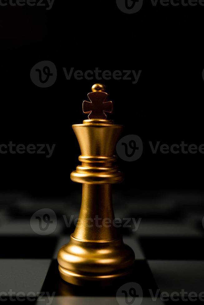 Golden Chess King standing alone on the chessboard photo