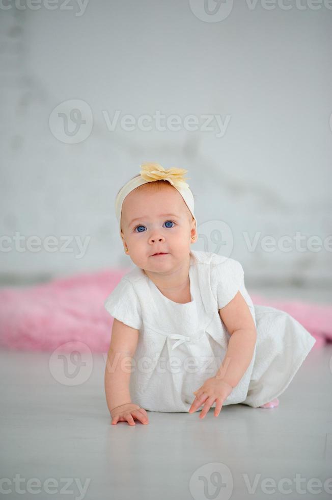 Little cute girl learns to crawl. photo