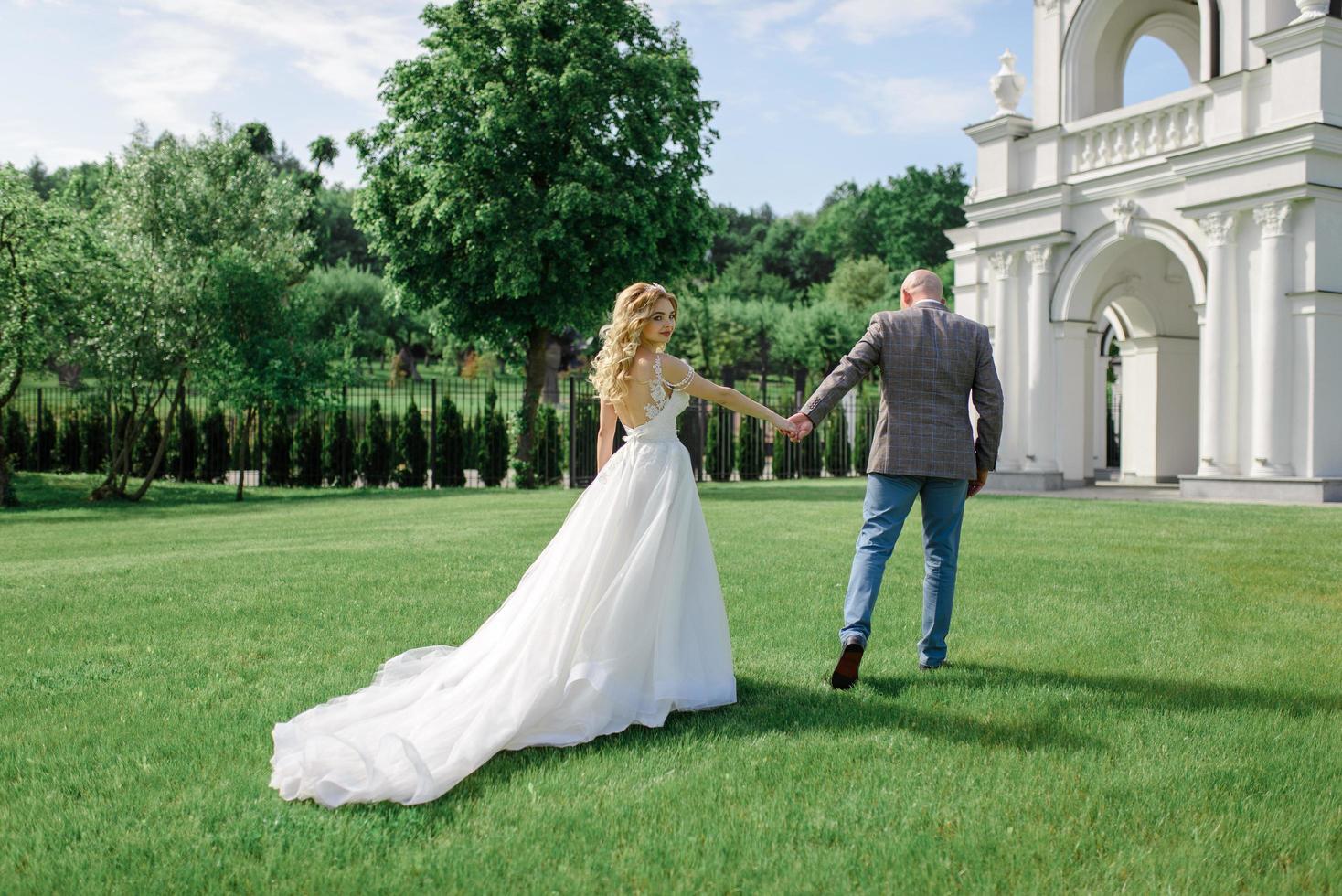 The bride and groom hold each other's hands. A man and a woman look into each other's eyes. photo