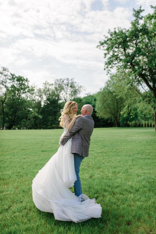 The bride and groom hold each other's hands. A man and a woman look into each other's eyes. photo