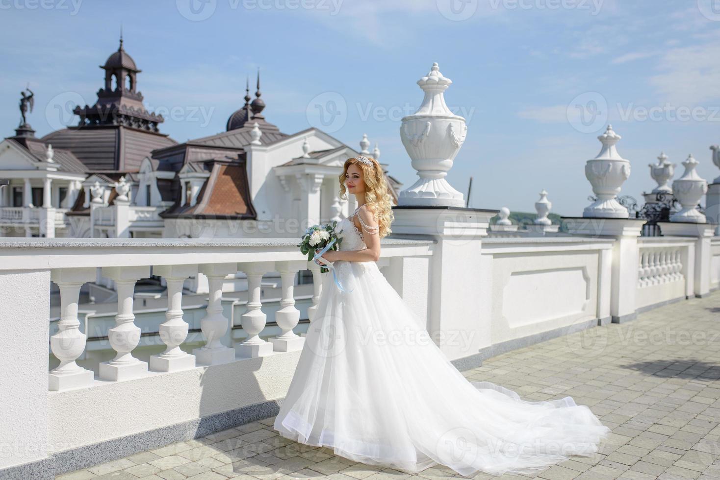 Portrait of a beautiful blonde bride with a bouquet. photo