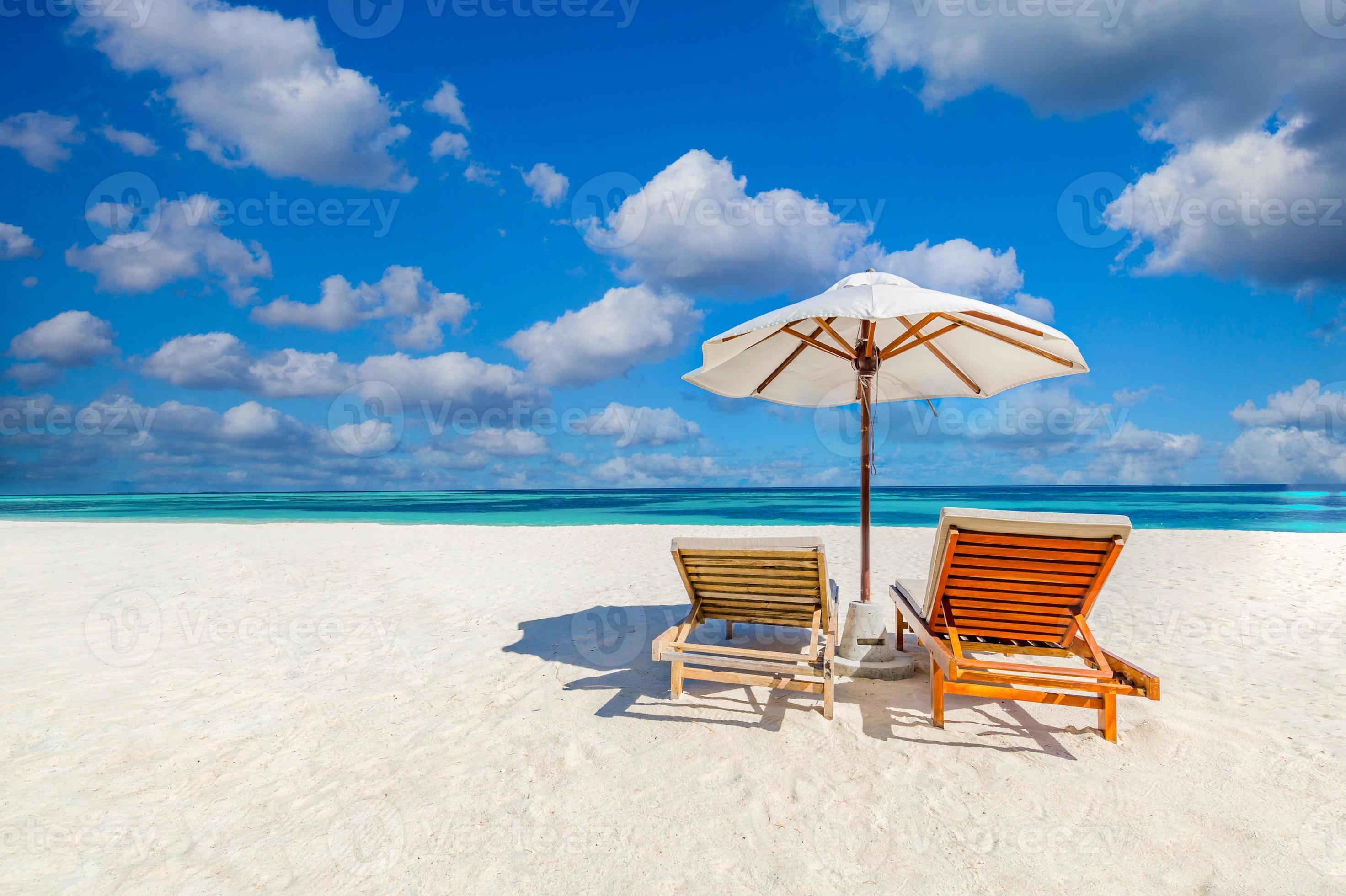 Tranquil beach scene, couple chairs, umbrella. Exotic tropical beach