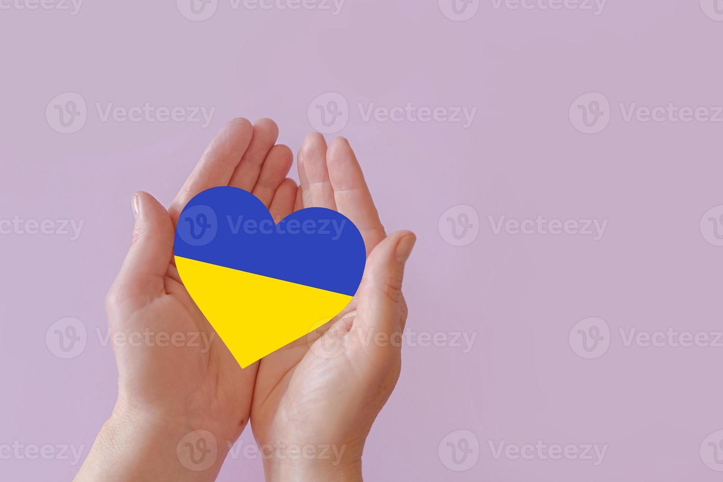 love blue and yellow heart in hands on colorful background.  Ukraine concept photo